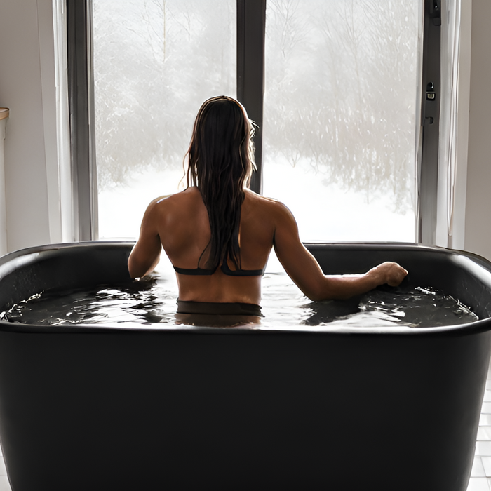 woman on a cold plunge black tub